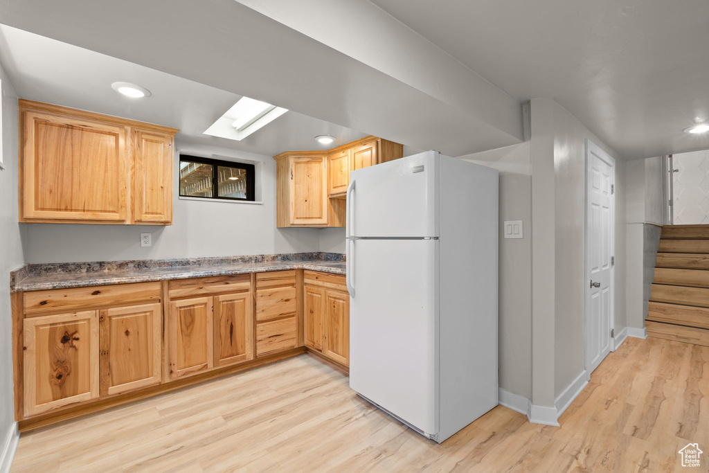 Kitchen with freestanding refrigerator, light wood-type flooring, recessed lighting, and light brown cabinets