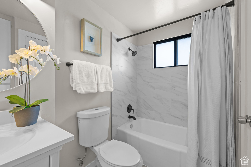 Full bathroom featuring shower / bath combo and vanity