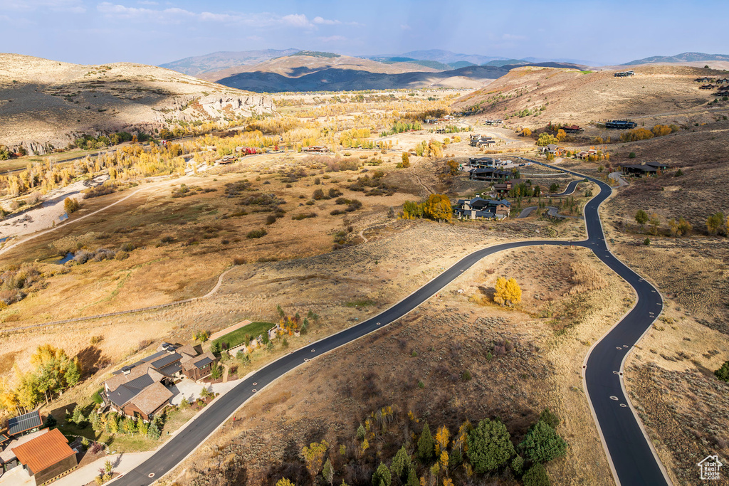 Aerial overview of property's location featuring a mountainous background