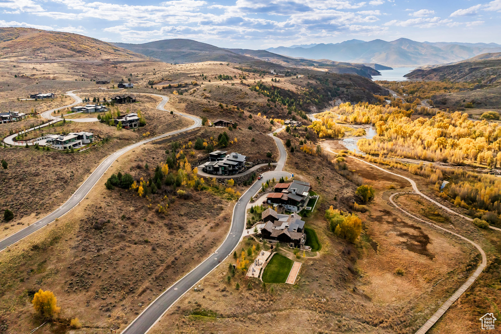 Aerial view of property's location featuring a mountainous background