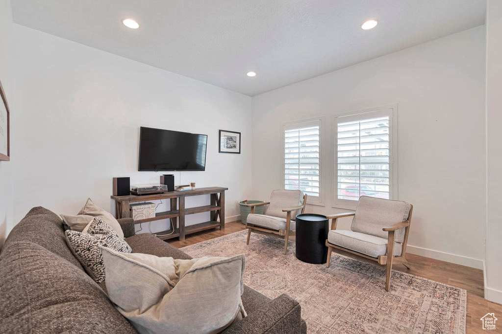 Living area featuring wood finished floors and recessed lighting