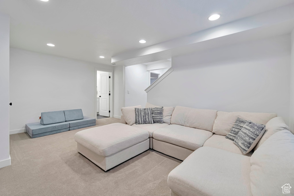 Carpeted living room featuring recessed lighting and baseboards