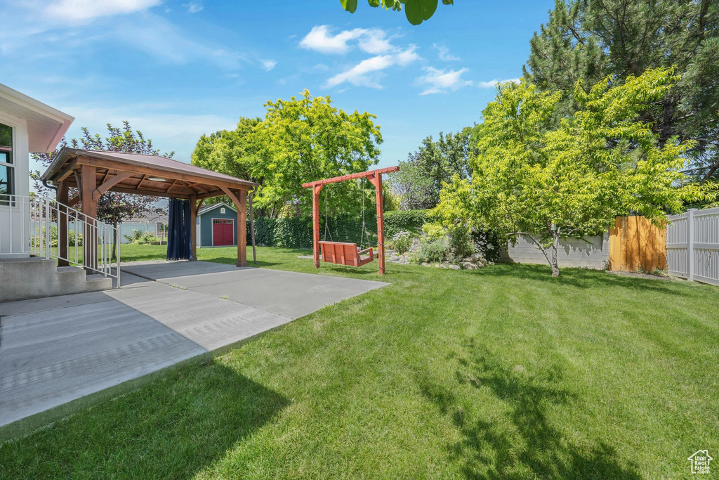 View of yard with a storage unit, a patio, and a gazebo