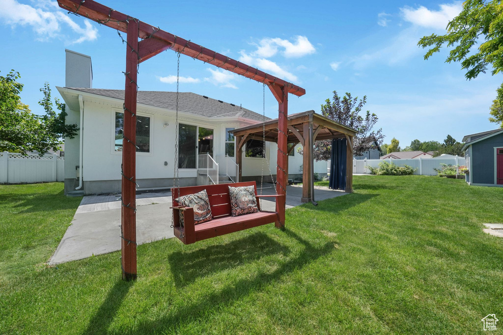 Fenced backyard with a patio and a gazebo