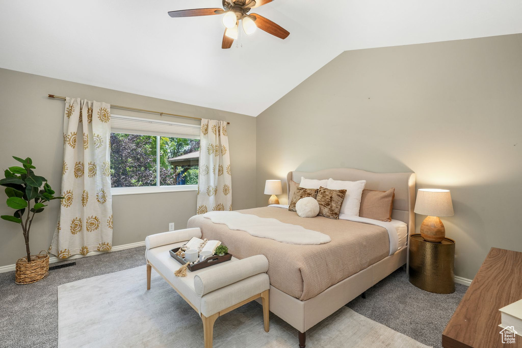 Bedroom featuring carpet flooring, lofted ceiling, and ceiling fan