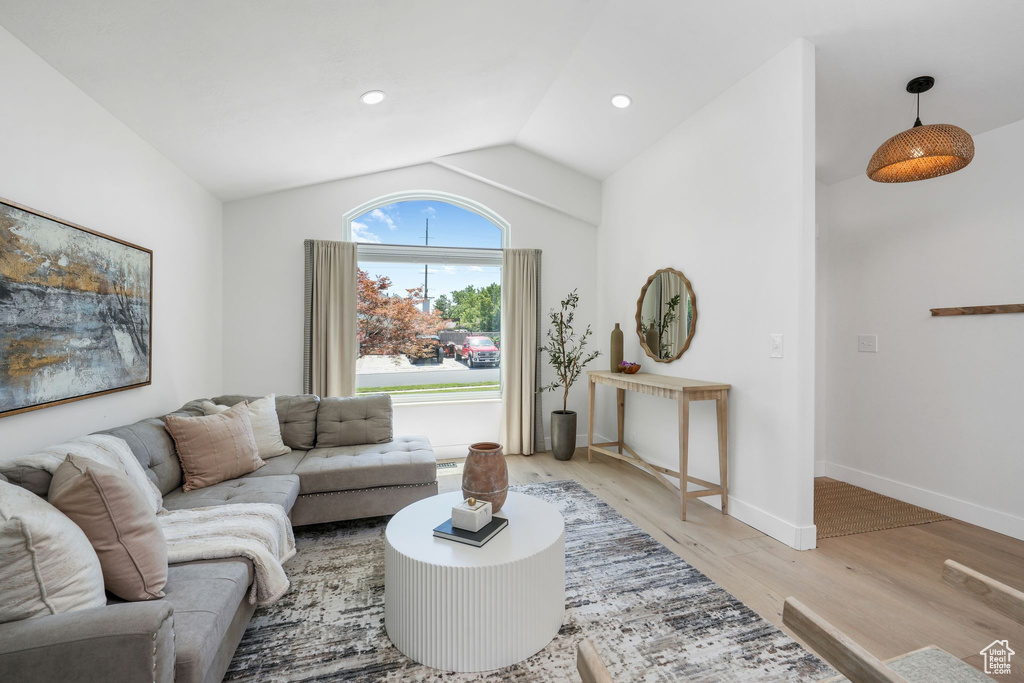 Living area featuring vaulted ceiling, light wood-type flooring, and recessed lighting