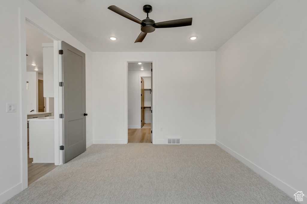 Unfurnished bedroom featuring light carpet, recessed lighting, and ceiling fan
