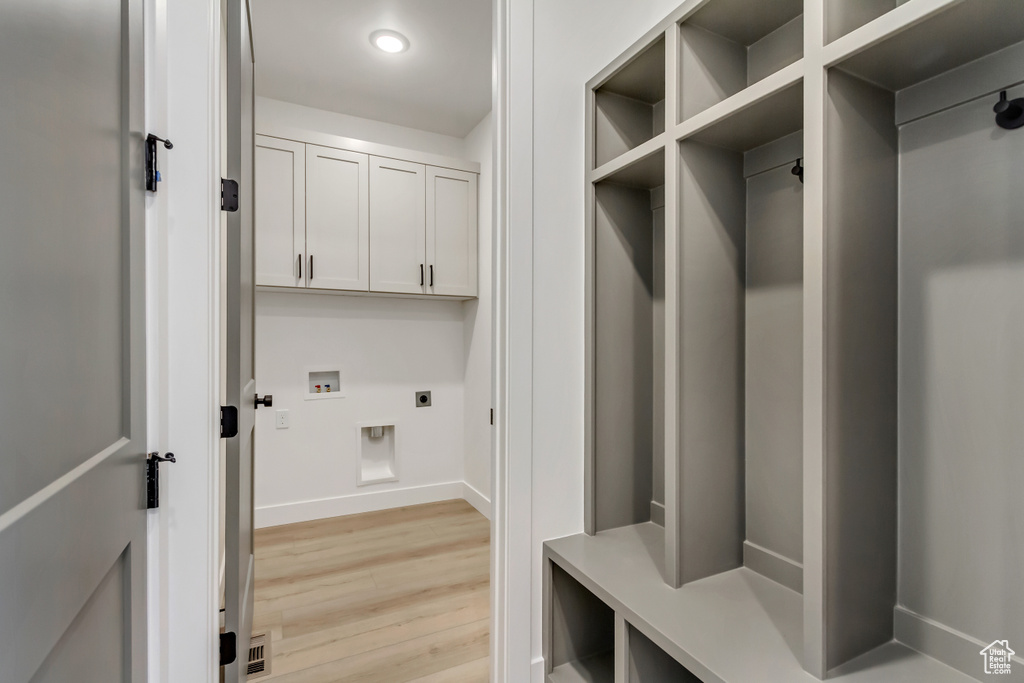 Mudroom with light wood-type flooring and baseboards