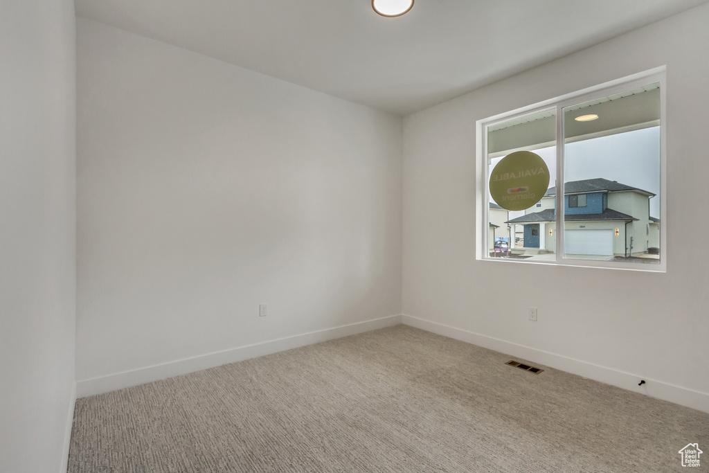 Empty room with carpet floors and baseboards