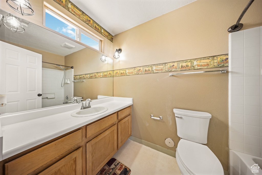 Bathroom featuring vanity and shower / washtub combination