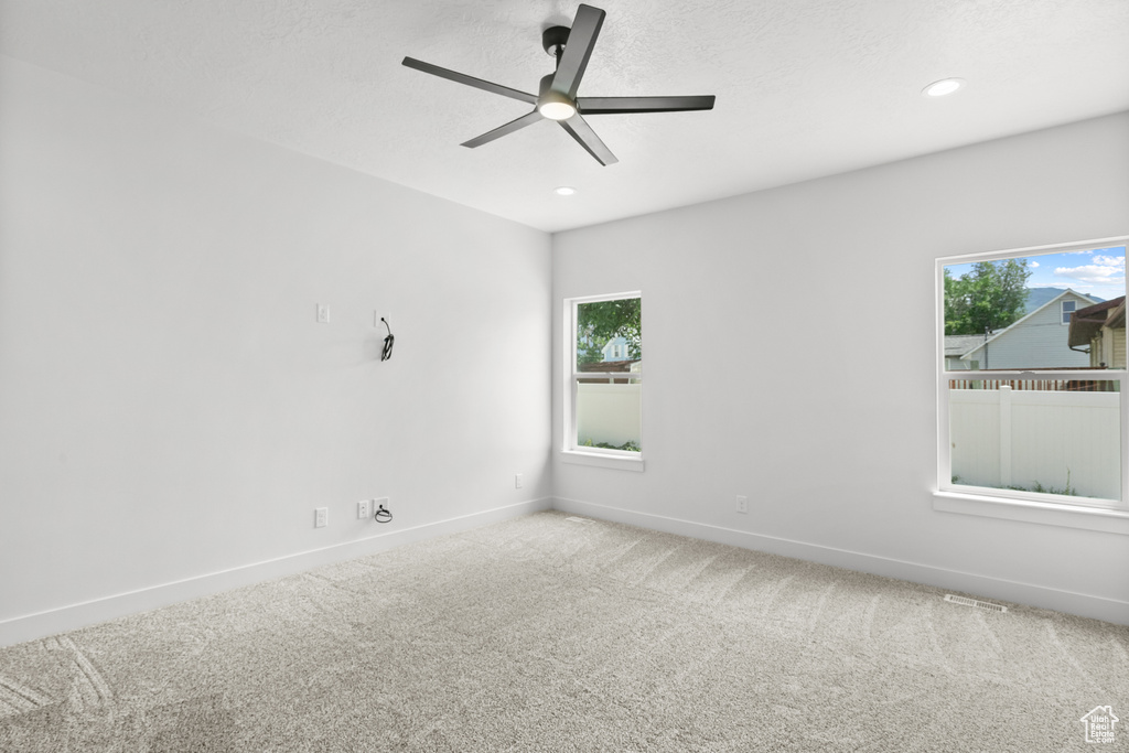 Spare room with ceiling fan, carpet flooring, healthy amount of natural light, and recessed lighting