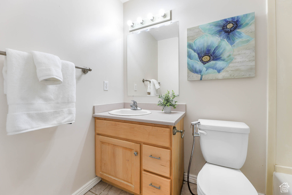 Bathroom featuring vanity and toilet