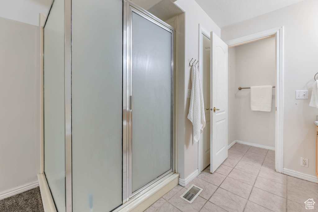 Bathroom featuring a stall shower and tile patterned flooring