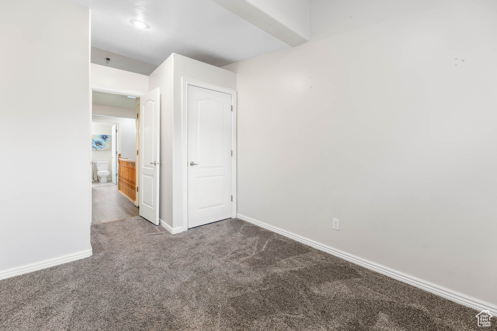 Unfurnished room with carpet flooring and baseboards