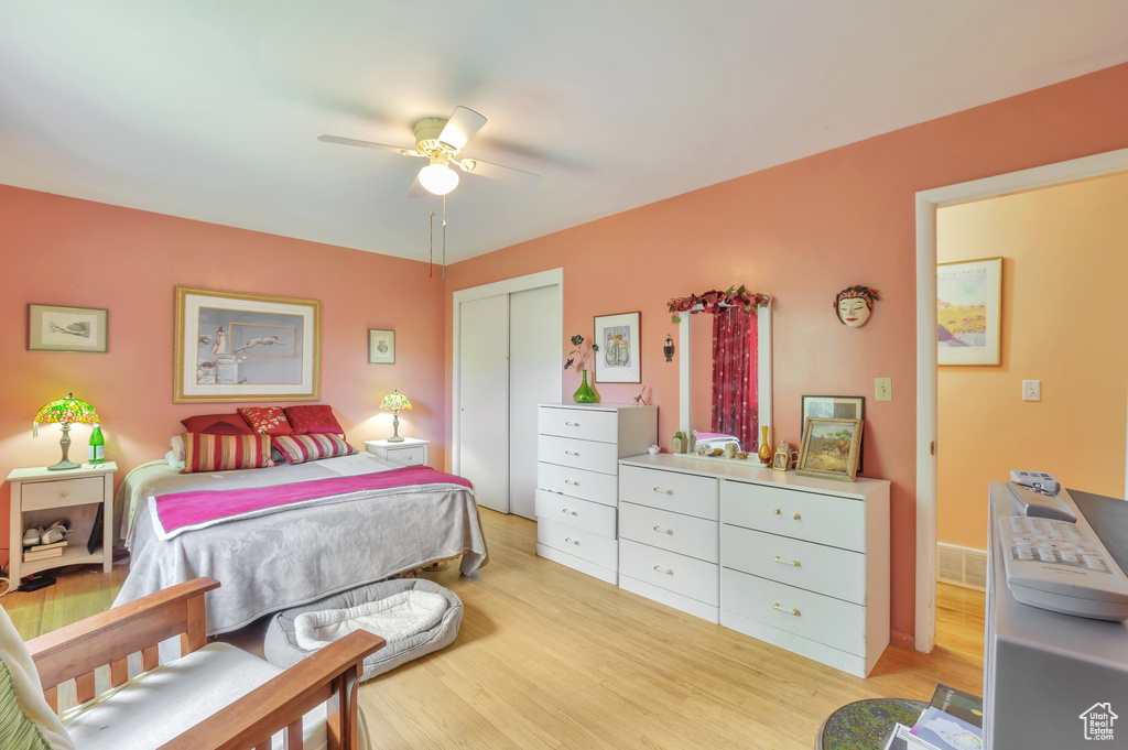 Bedroom featuring light wood-type flooring, a closet, and a ceiling fan