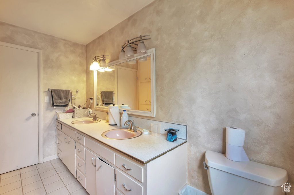 Bathroom with tile patterned floors and double vanity