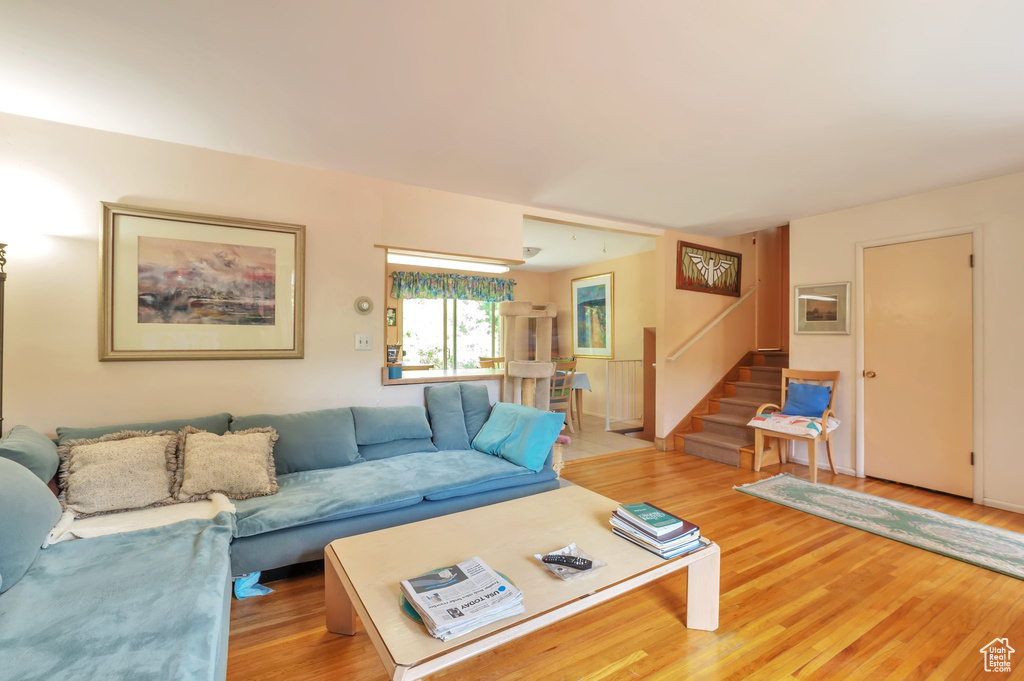 Living room featuring stairway and light wood-type flooring
