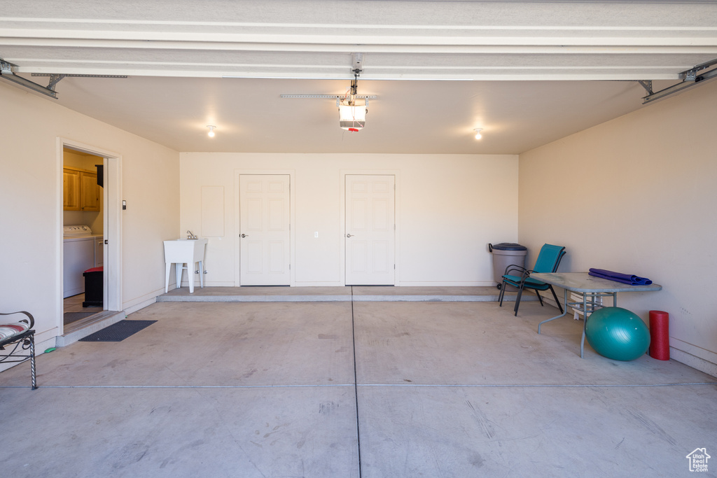 Garage featuring washer / dryer and a garage door opener