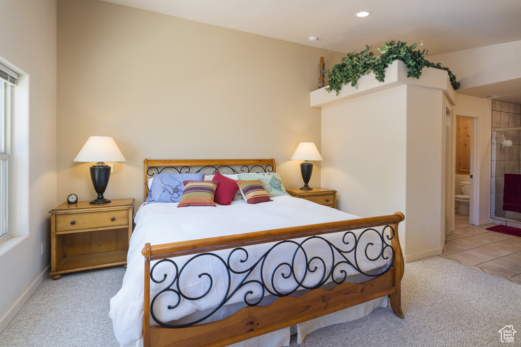 Carpeted bedroom with ensuite bathroom and recessed lighting