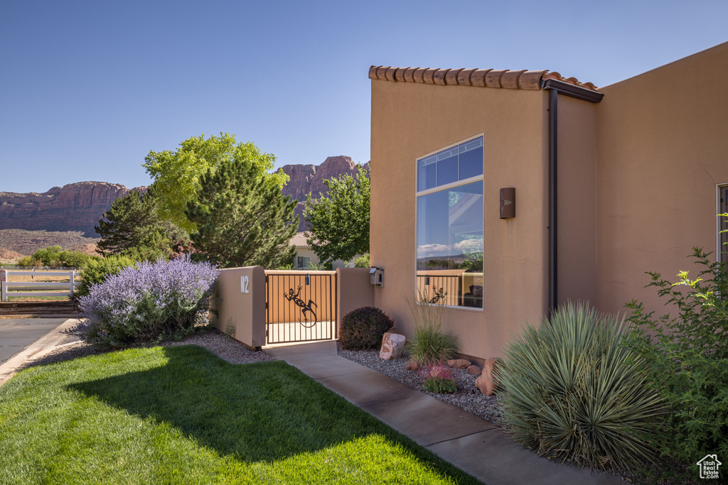 Fenced yard with a mountain view and a gate