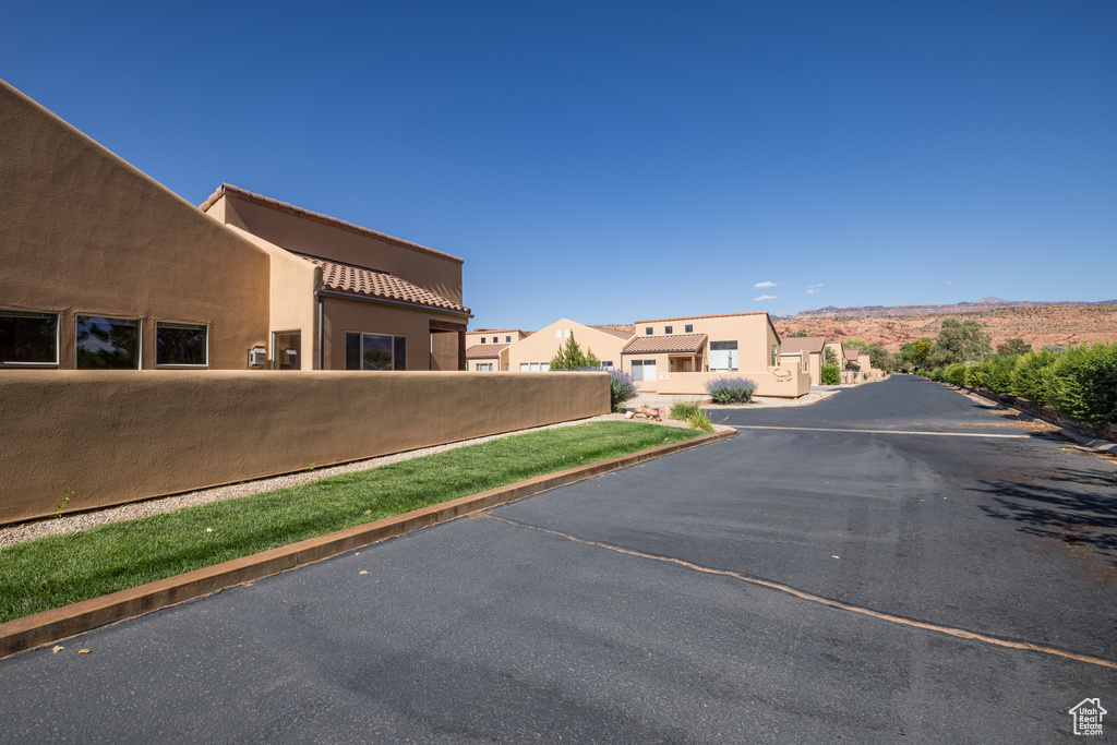 View of asphalt road with curbs