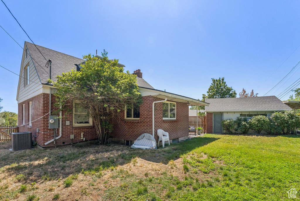 View of home\'s exterior featuring brick siding and a chimney