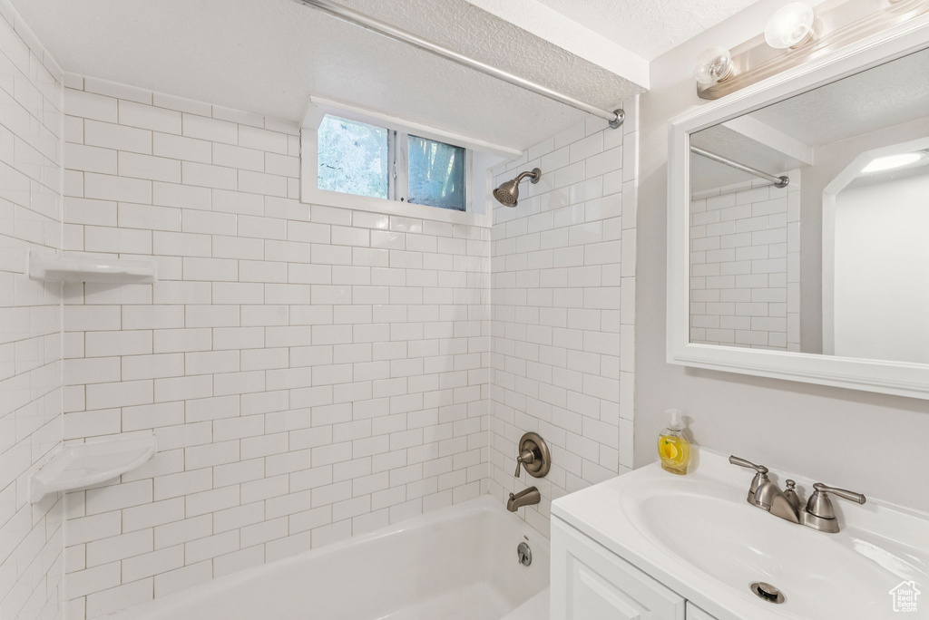 Bathroom featuring bathtub / shower combination and vanity