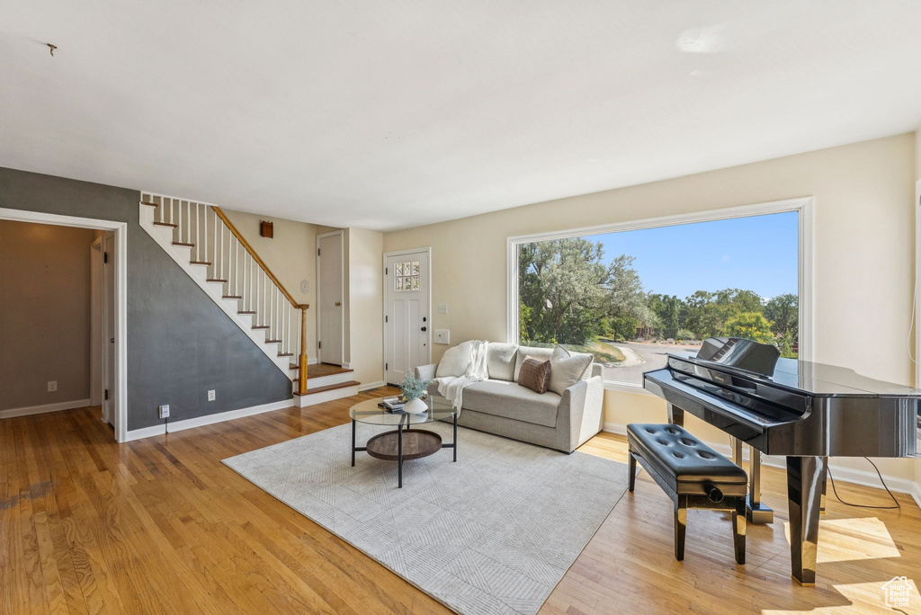 Living area with stairway and light wood-style flooring