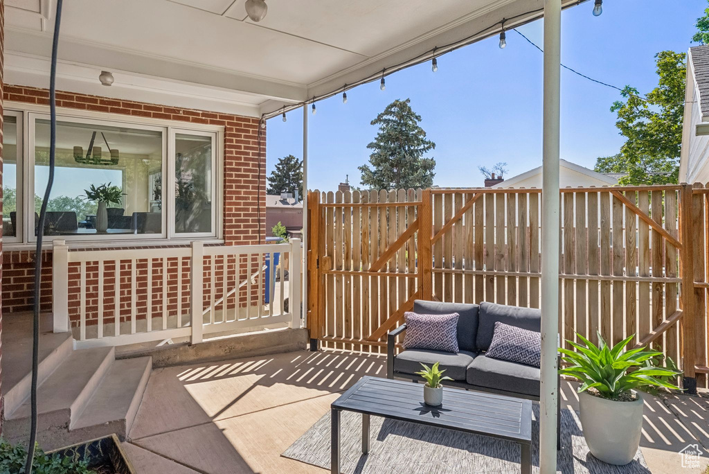 View of patio with an outdoor hangout area