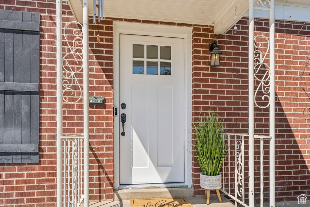 Property entrance featuring brick siding