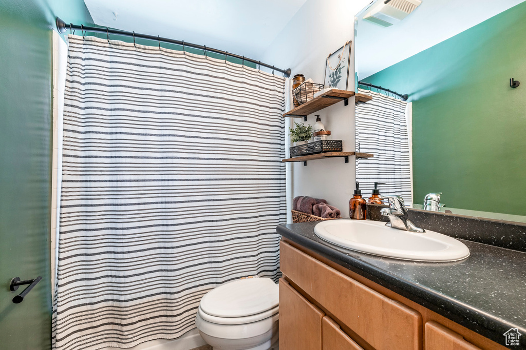Full bath featuring vanity and curtained shower