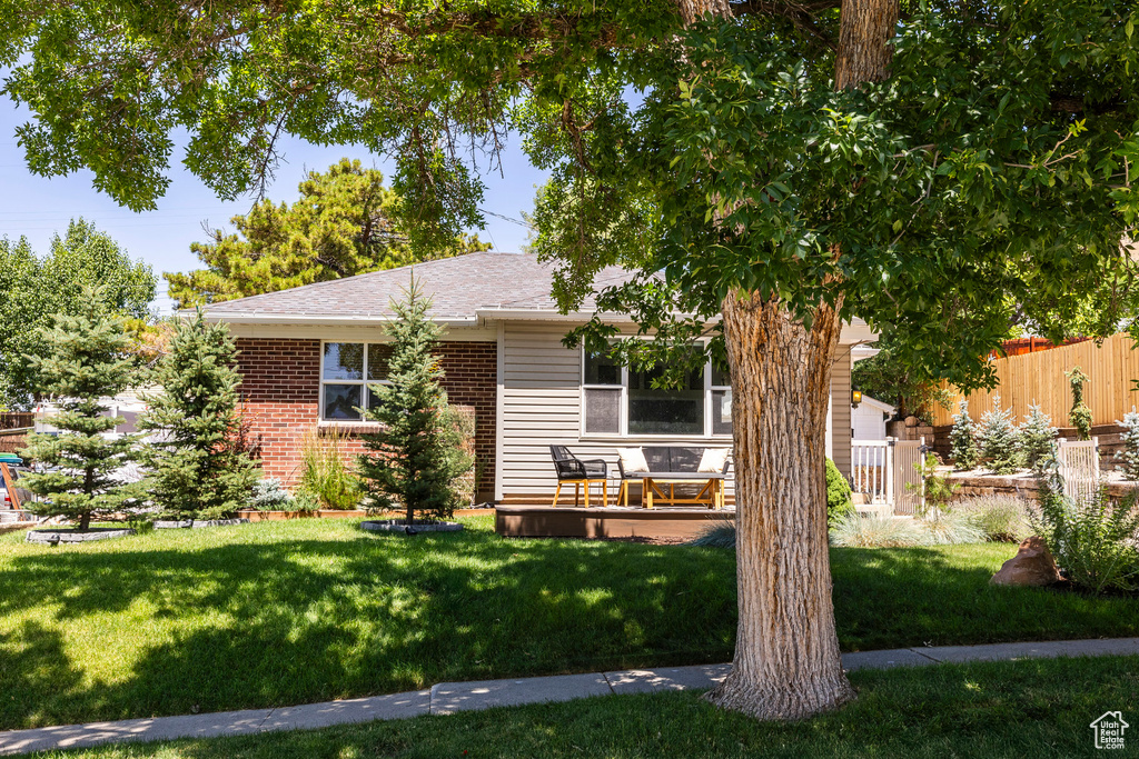 View of front of home with brick siding and a shingled roof