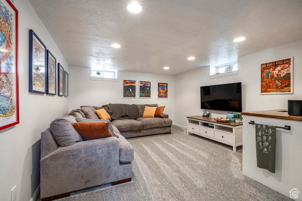 Living room with recessed lighting, carpet flooring, and a textured ceiling