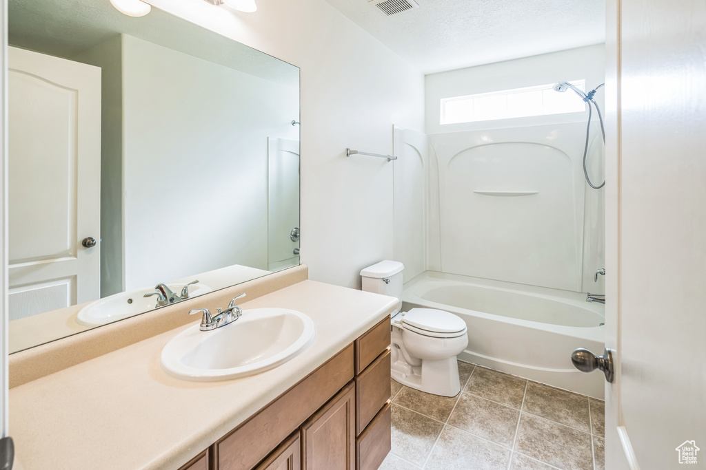 Full bath featuring vanity, bathing tub / shower combination, and tile patterned floors