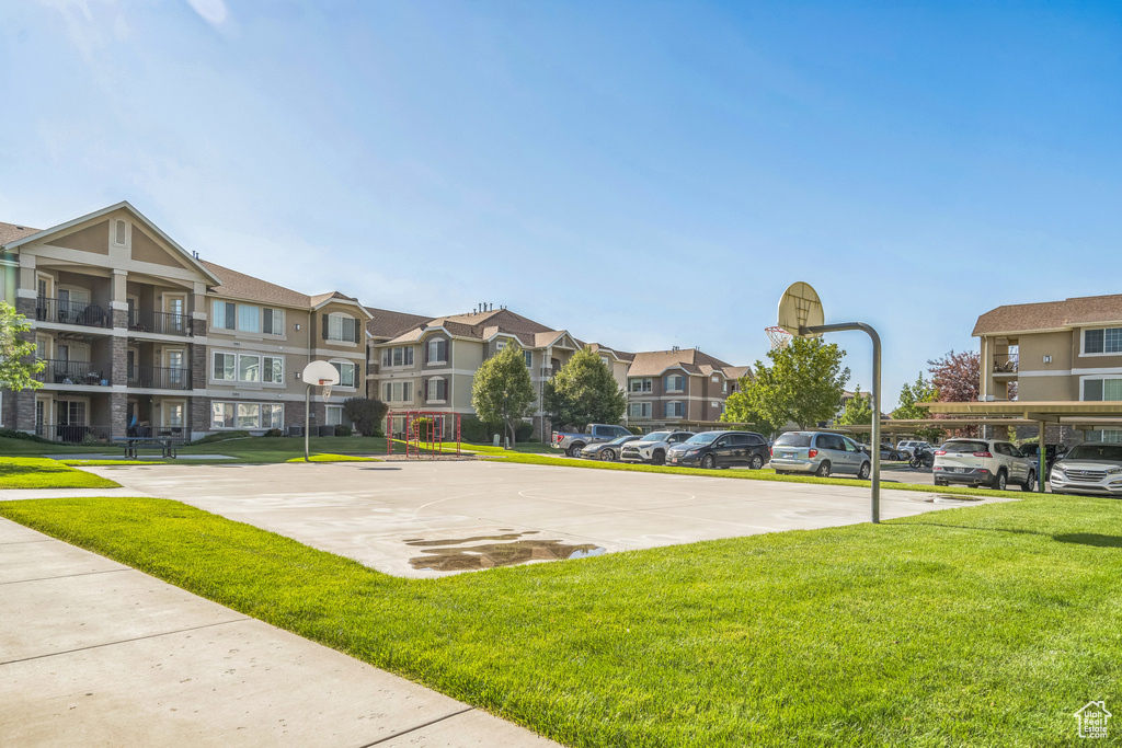 View of basketball court featuring a yard, community basketball court, and a residential view