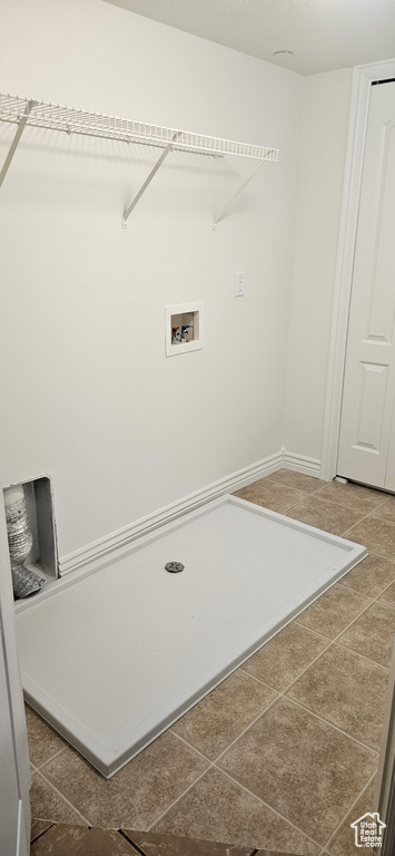 Laundry room featuring hookup for a washing machine and tile patterned floors