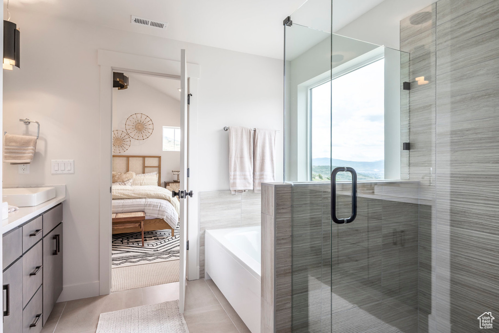 Full bath featuring connected bathroom, vanity, a bath, tile patterned floors, and a shower stall