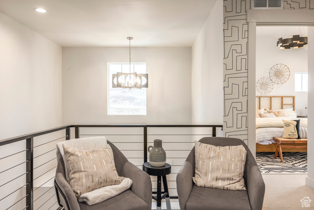 Living area with a chandelier, recessed lighting, and carpet flooring