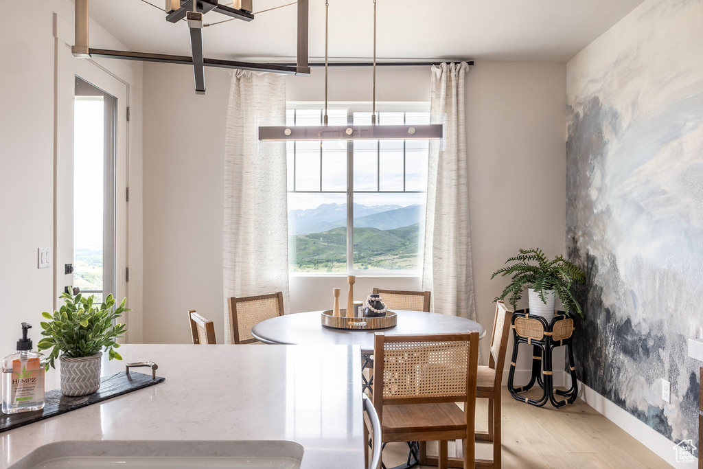 Dining area featuring light wood-style flooring and an accent wall