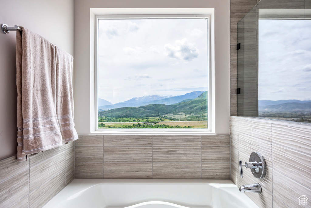 Full bath featuring healthy amount of natural light, a garden tub, and a mountain view