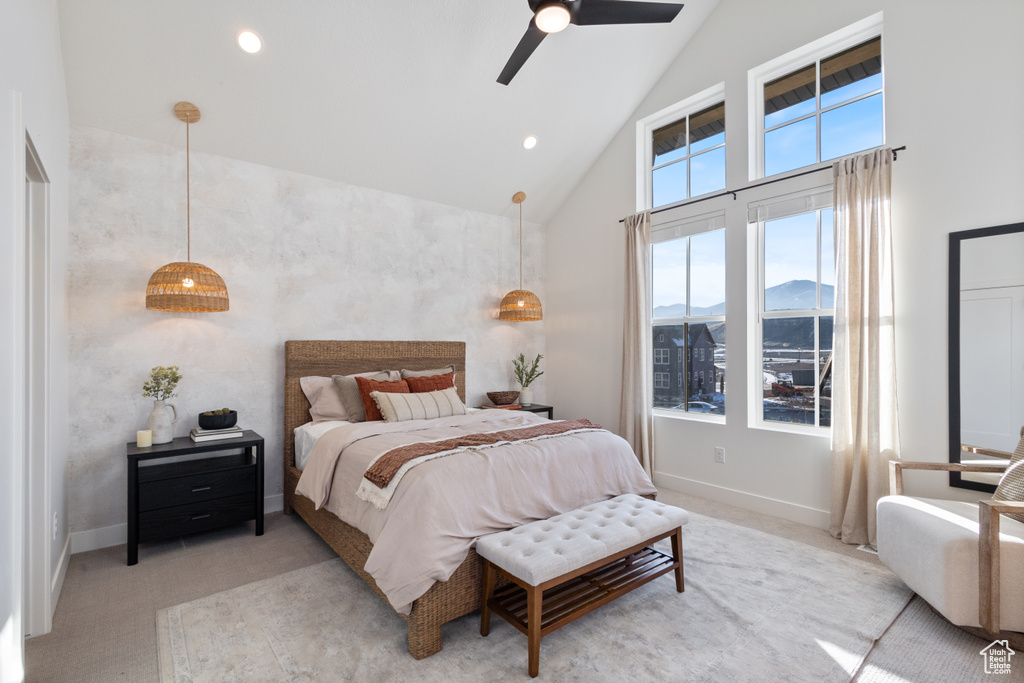 Bedroom featuring high vaulted ceiling, light colored carpet, a mountain view, and a ceiling fan