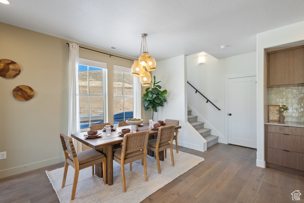 Dining area featuring stairs and wood-type flooring