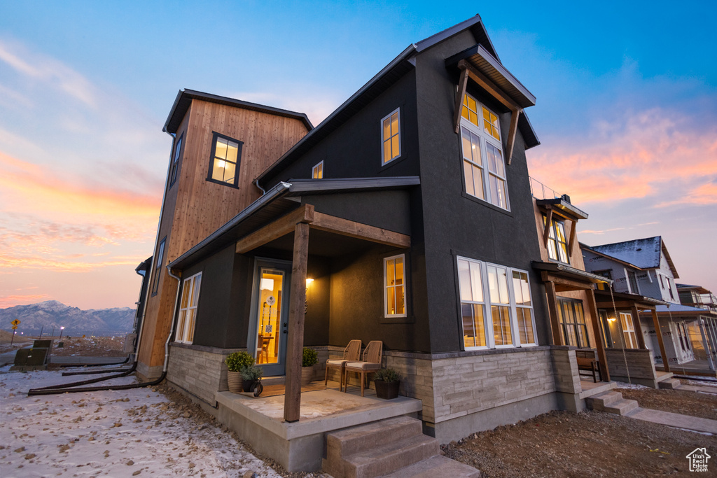 Contemporary house featuring stucco siding and stone siding
