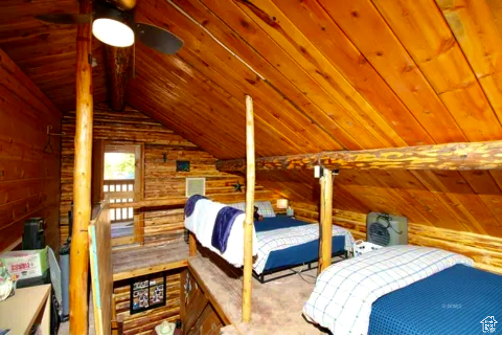 Bedroom featuring wooden ceiling, lofted ceiling, and wood walls