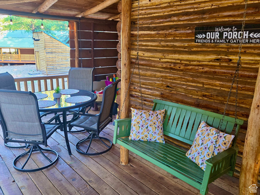 Wooden terrace featuring outdoor dining area