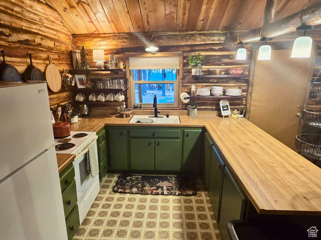 Kitchen with green cabinetry, butcher block countertops, log walls, white appliances, and wooden ceiling