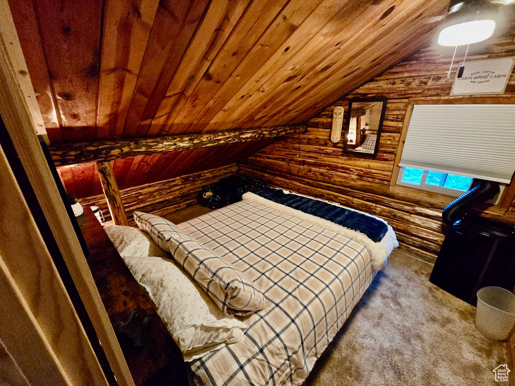 Bedroom featuring wooden walls, vaulted ceiling, wood ceiling, log walls, and carpet