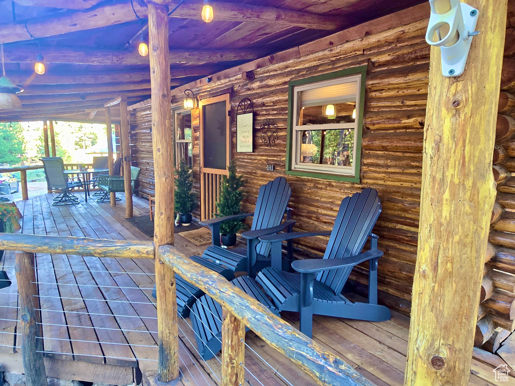 Wooden porch featuring outdoor dining area