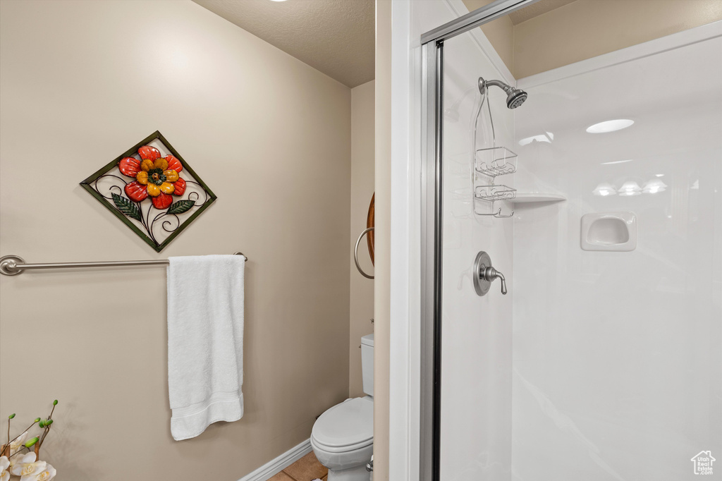 Full bathroom with a stall shower and toilet