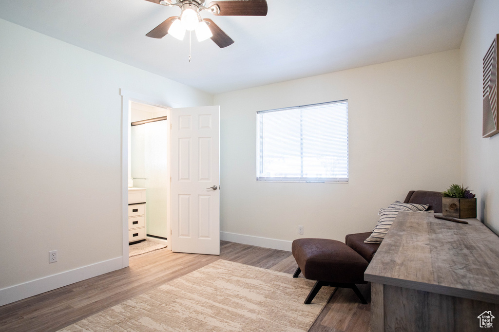 Living area featuring wood finished floors and ceiling fan